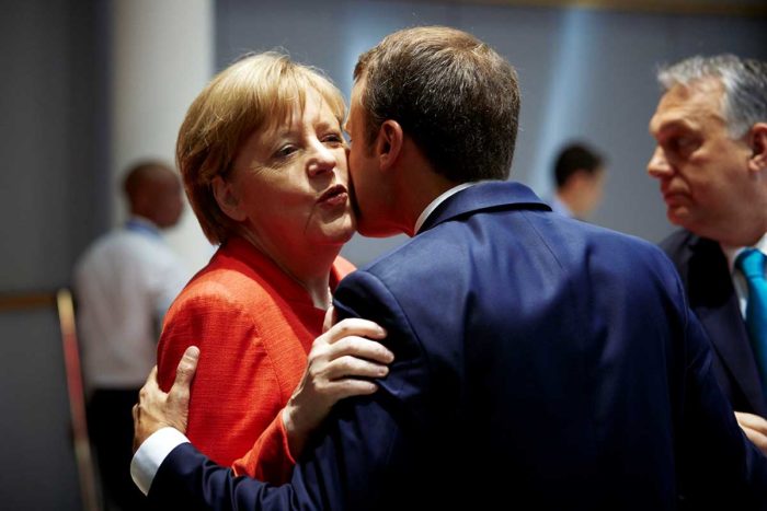 Macron kisses Merkel