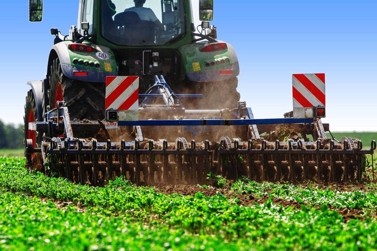 Agriculture - A farmer ploughing his field with a tractor