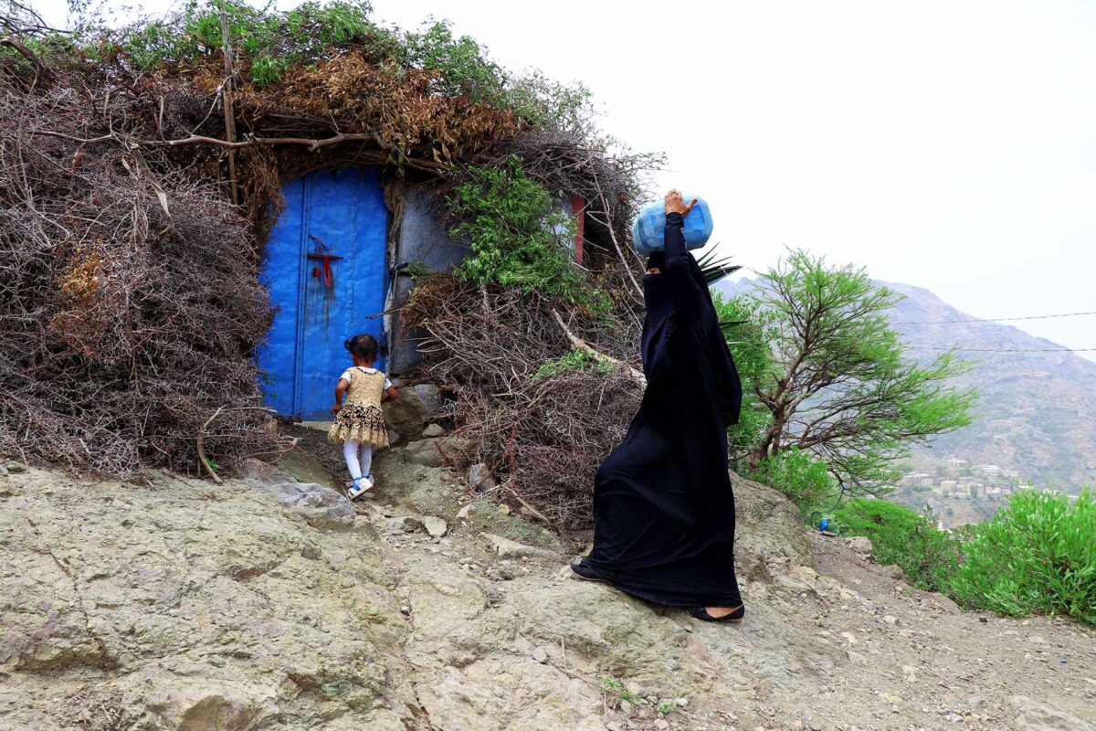 A woman carrying water provided by CARE